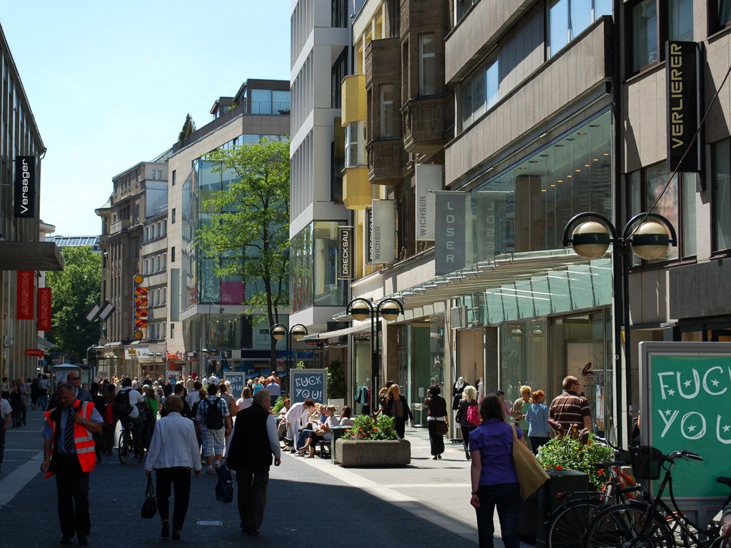 A Düsseldorf shopping street with a small sign reading FUCK YOU