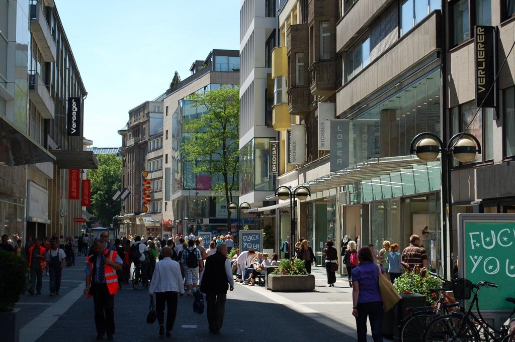 A Düsseldorf pedestrian zone with a building sign altered to read ASSHOLE