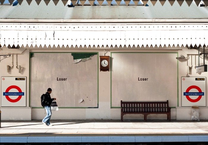 A London Underground platform wall carrying the word Loser twice